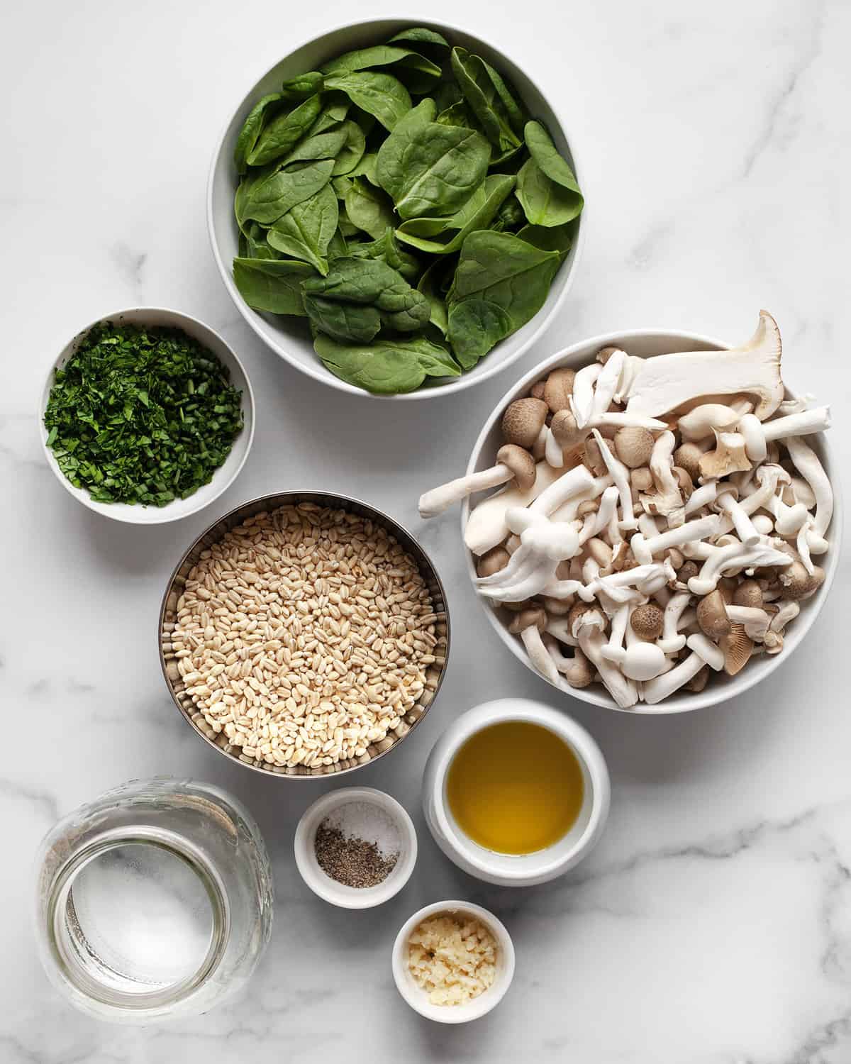Ingredients including barley, mushrooms, spinach, herbs, olive oil, garlic, salt, pepper and water.