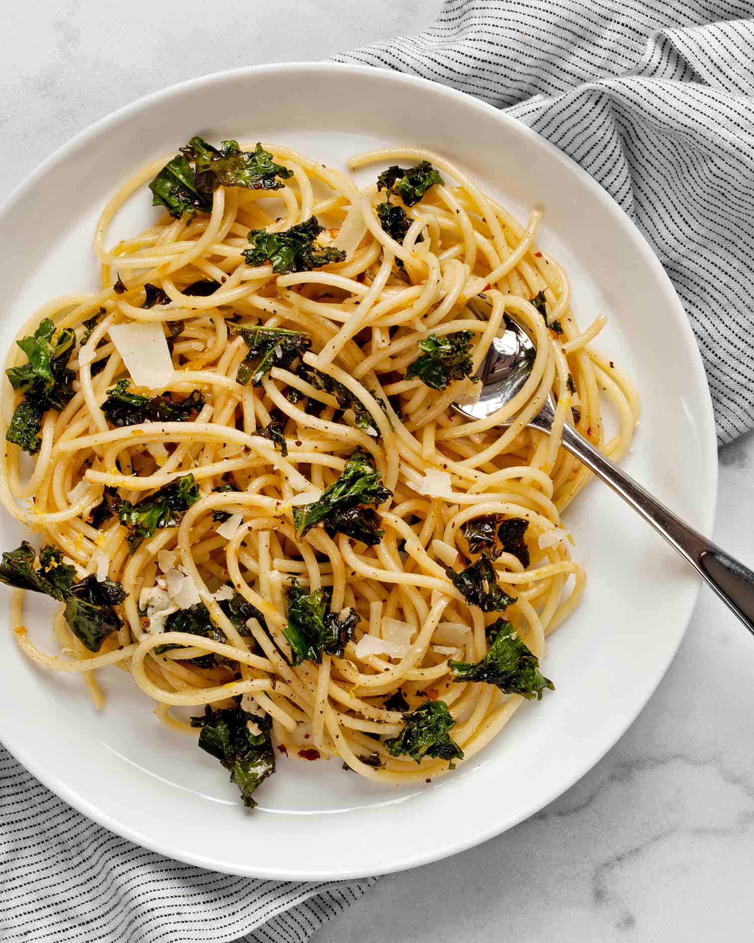 Lemon pepper pasta on a plate with a fork.