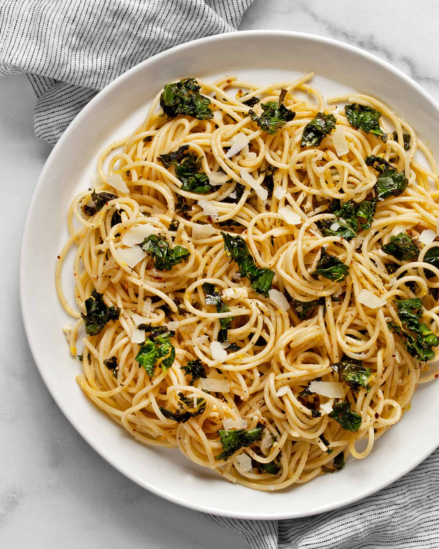 Lemon pepper pasta with kale on a plate.