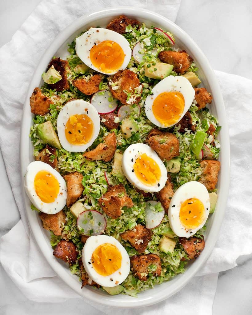 Brussels sprout salad with hard-boiled eggs and bagel croutons