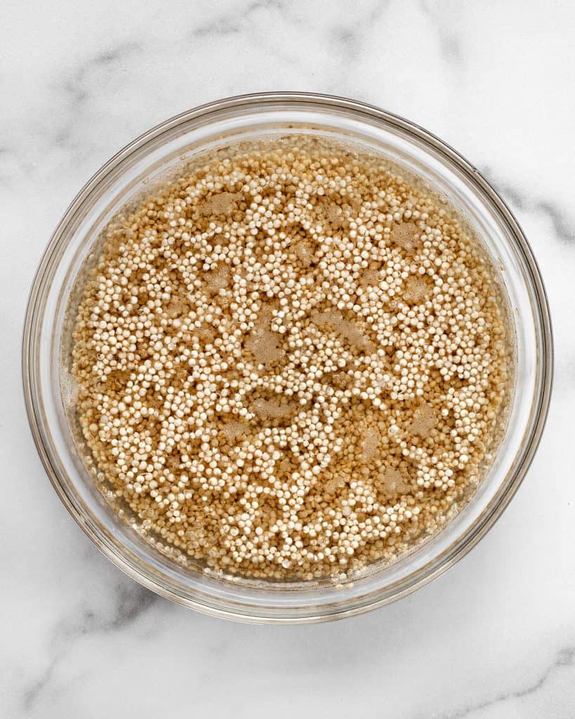 Quinoa soaking in water in a bowl