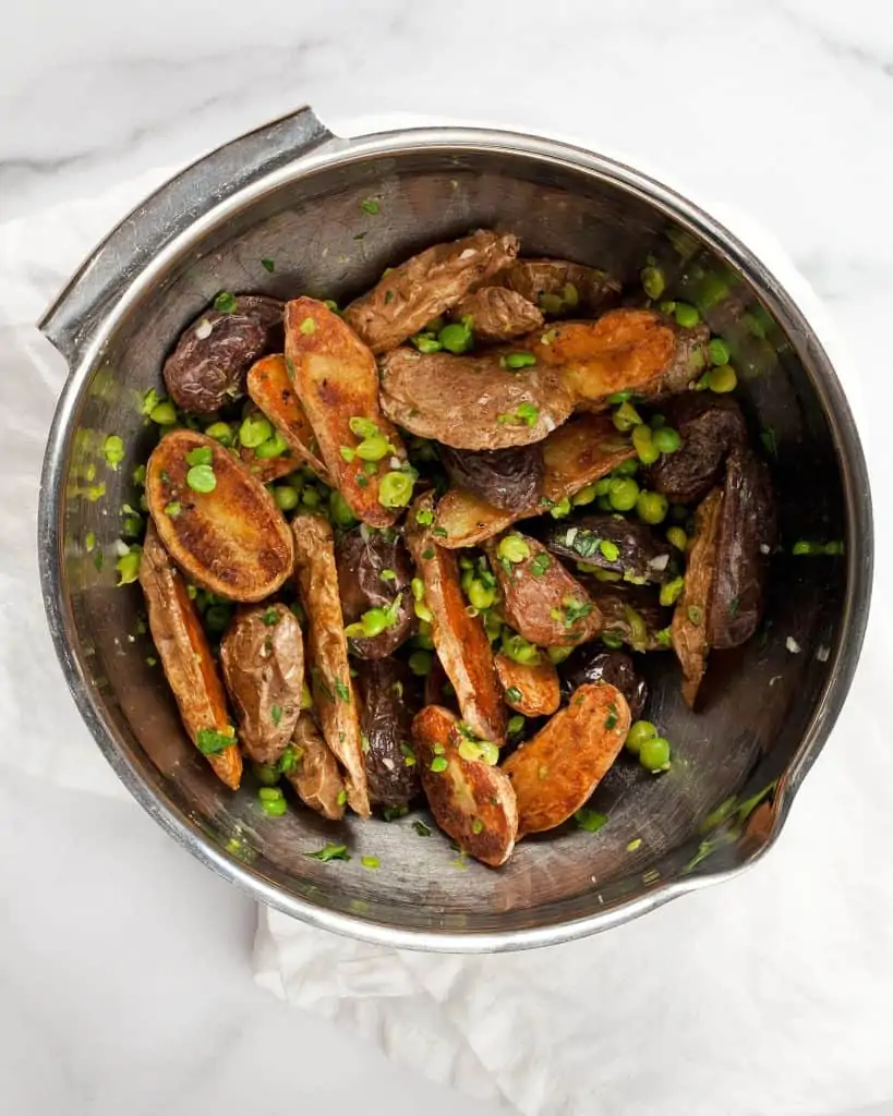 Stir the peas into the roasted potatoes in a bowl