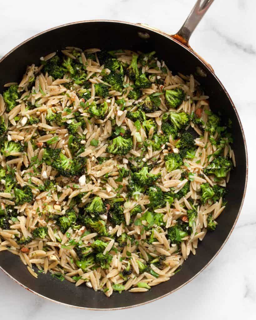 Orzo with roasted broccoli in a skillet
