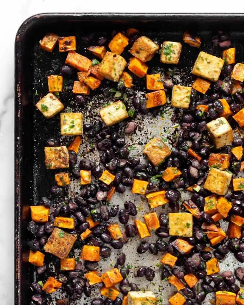 Baked tofu and sweet potatoes and black beans on sheet pan