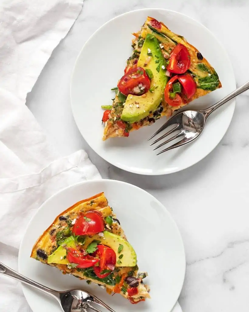 Two slices of frittata topped with avocado