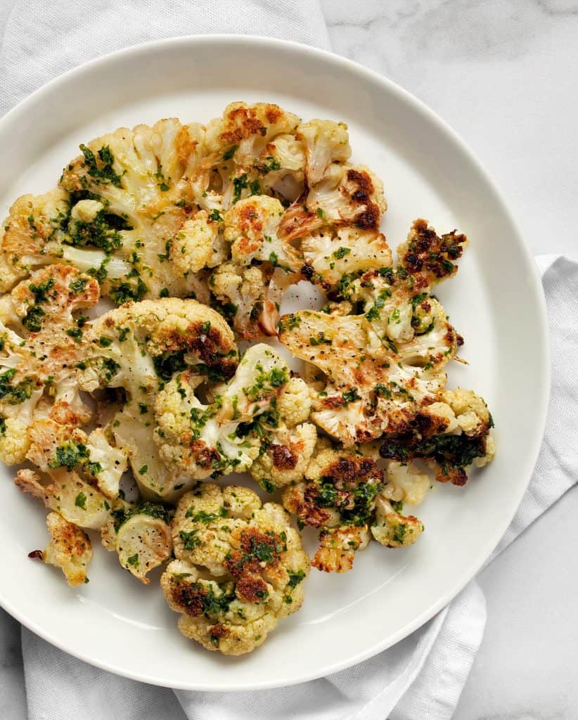 Roasted cauliflower dressed in vegan pesto