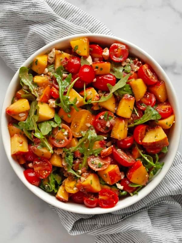 Peach tomato salad in a bowl.