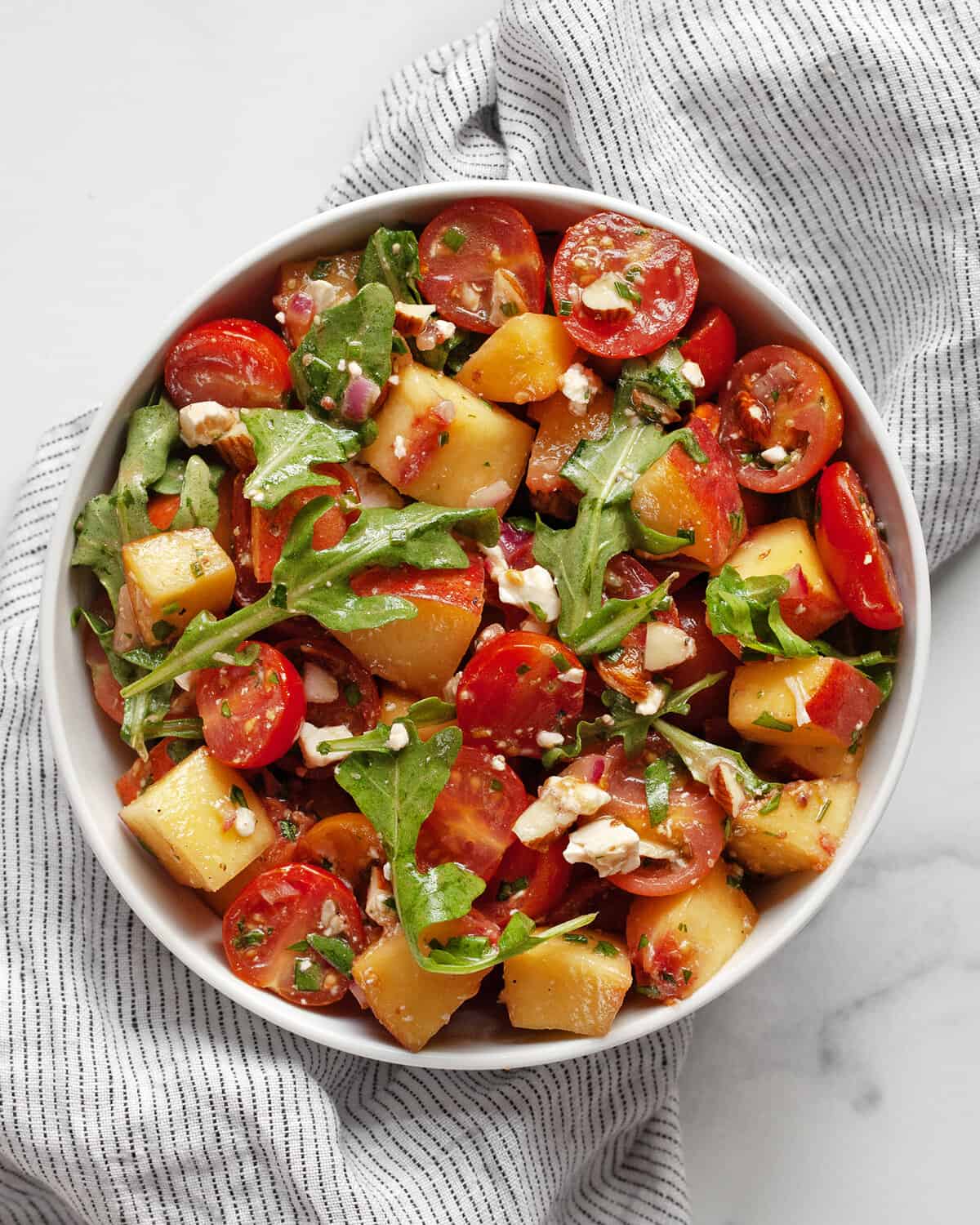 Balsamic tomato peach salad in a bowl.