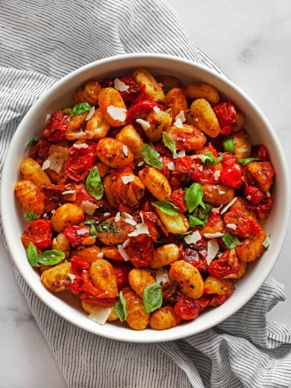 Sheet pan gnocchi with cherry tomatoes in a bowl.