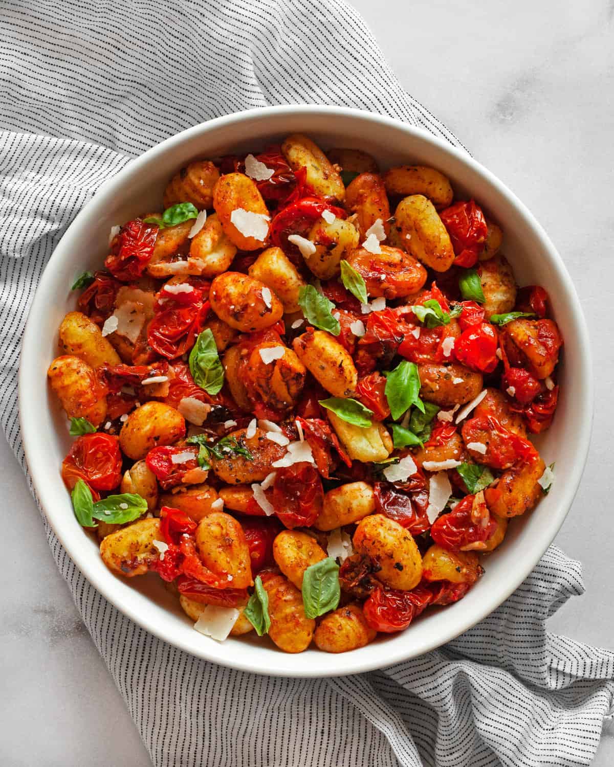 Sheet pan gnocchi with cherry tomatoes in a bowl.