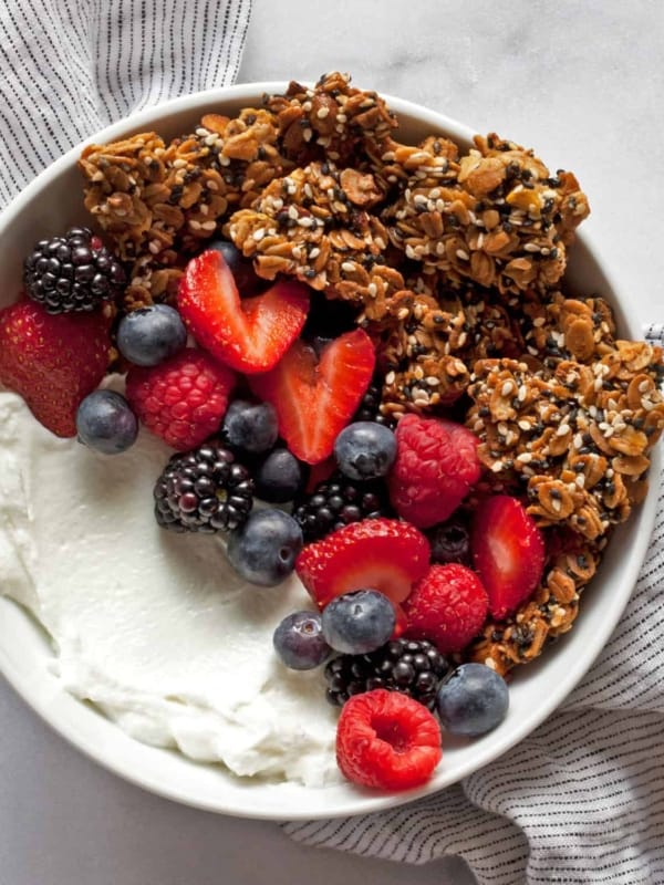 Granola in a bowl with berries and yogurt.