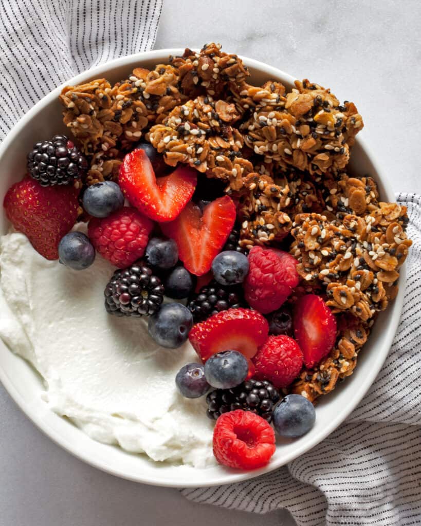 Granola in a bowl with berries and yogurt.