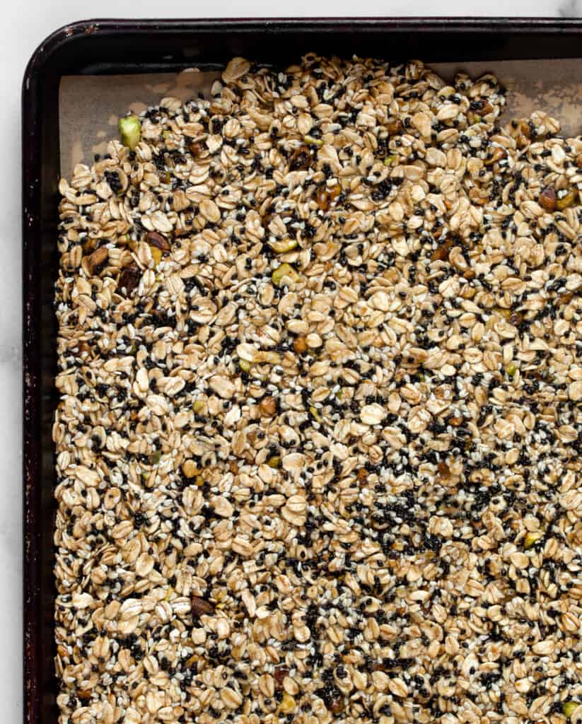 Granola on a sheet pan before it is baked