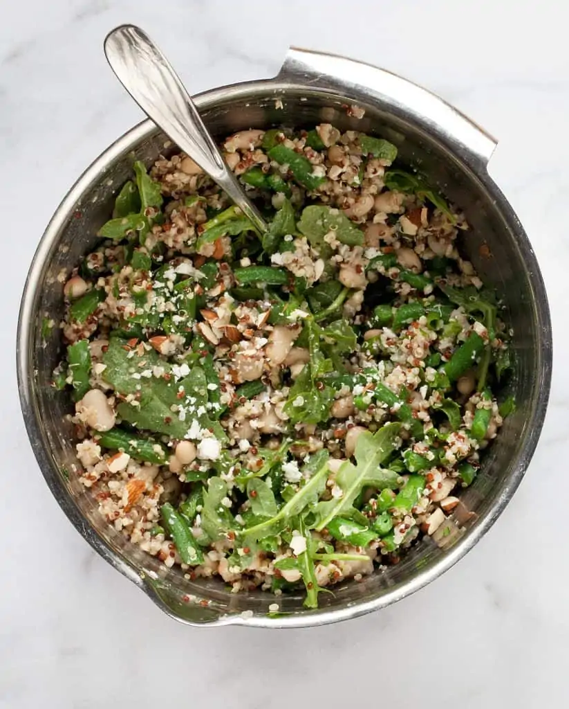 Combine the quinoa, beans and arugula in a bowl