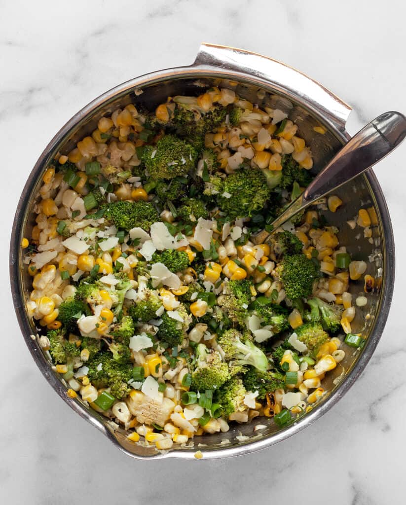 Combine the corn kernels, broccoli, scallions, parsley and pecorino in a bowl