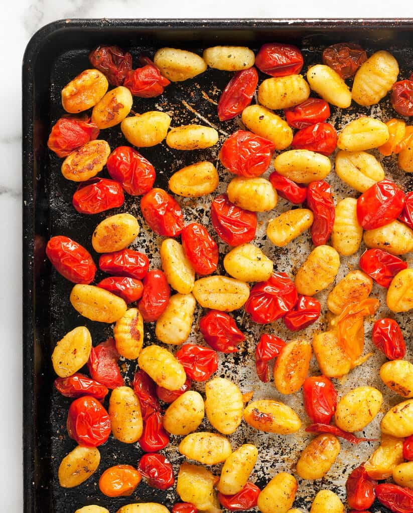 Baked gnocchi and tomatoes on a sheet pan
