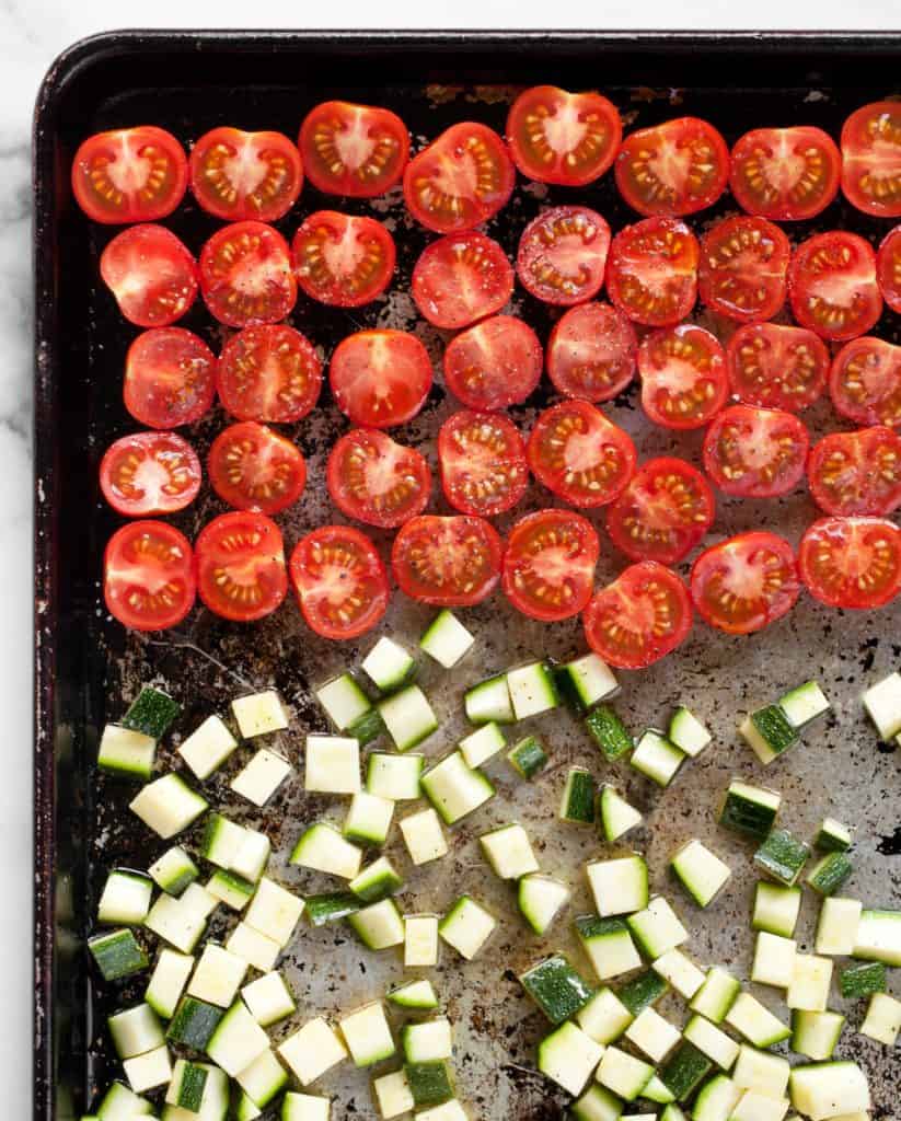 Tomatoes and zucchini on a sheet pan