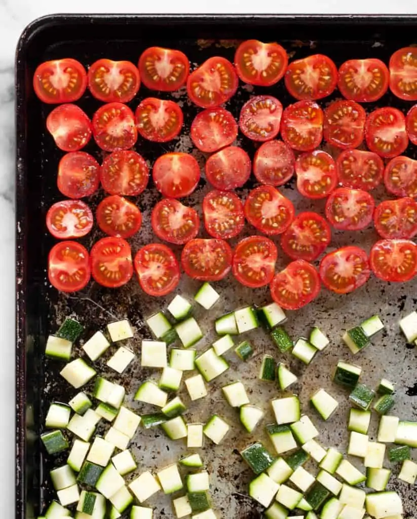 Tomatoes and zucchini on a sheet pan