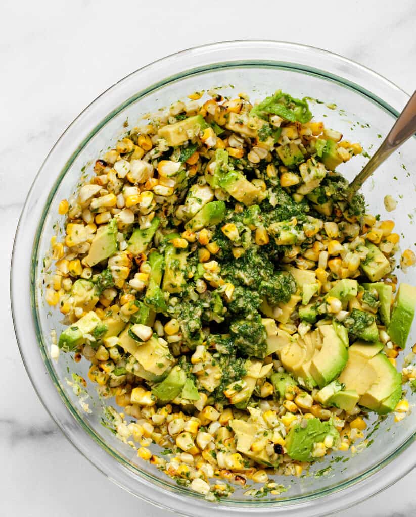 Stir the cilantro pesto into the grilled corn and avocadoes
