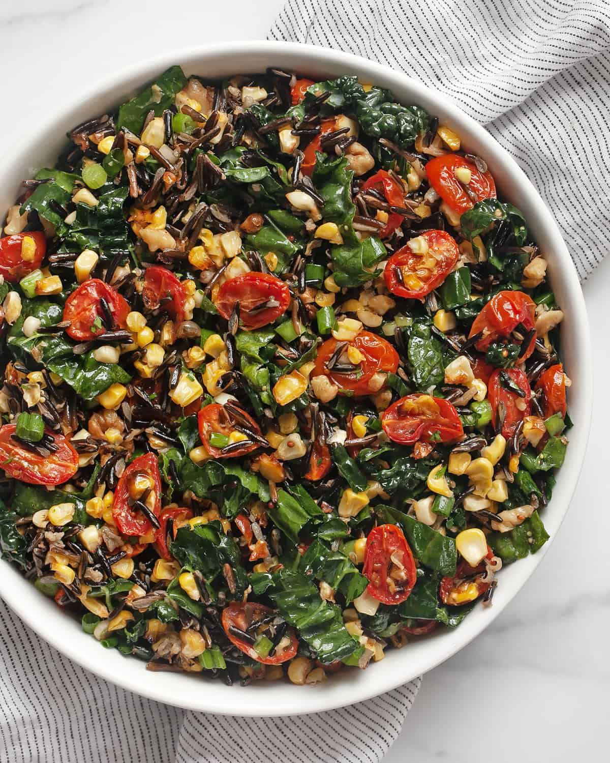 Roasted corn and tomato wild rice salad in a bowl.