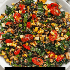 Roasted corn and tomato wild rice salad in on a plate.