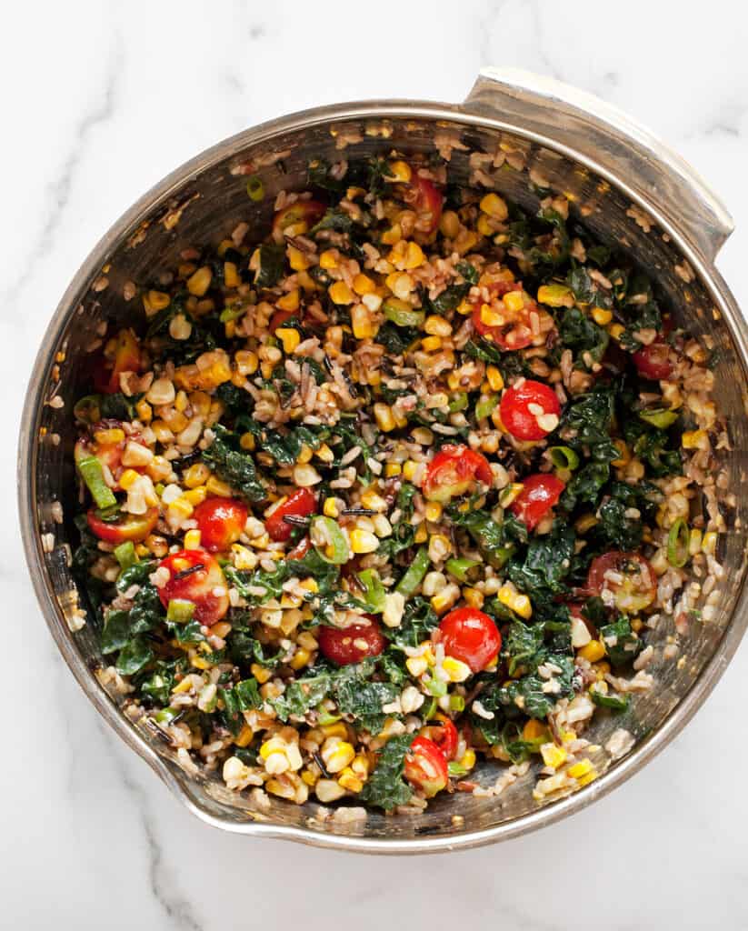 Stir together the wild rice, tomatoes, corn and kale