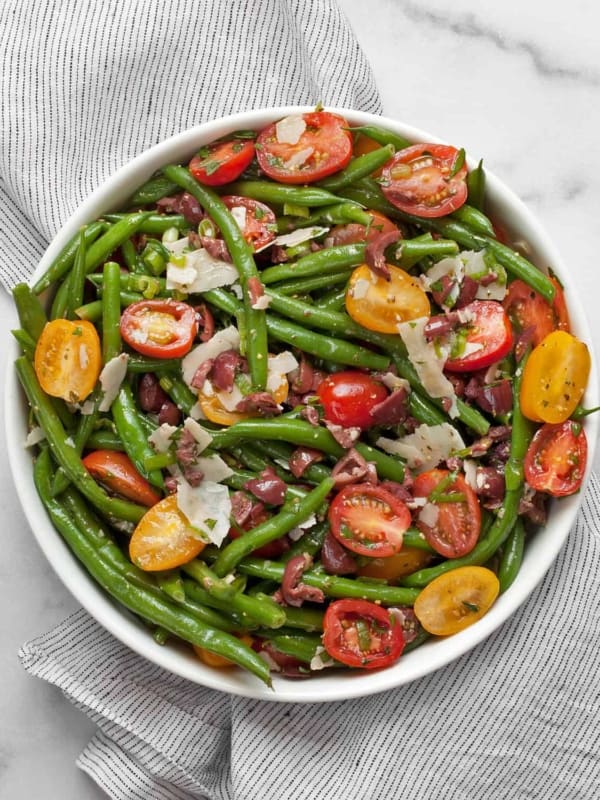 Green bean tomato olive salad in abowl.