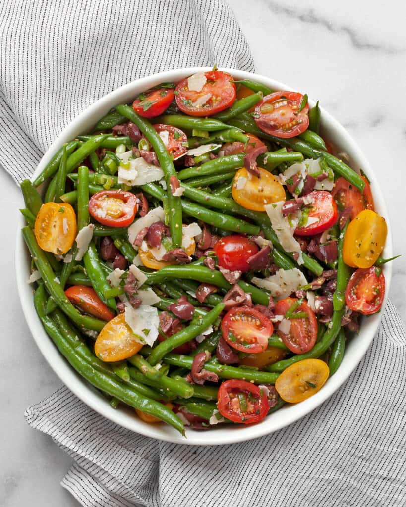 Green bean tomato olive salad in abowl.
