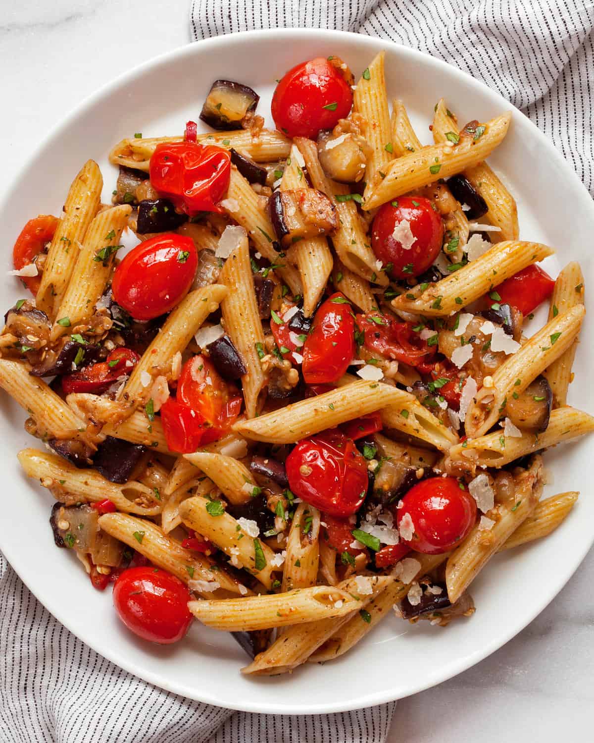 Cherry tomato eggplant pasta on a plate.