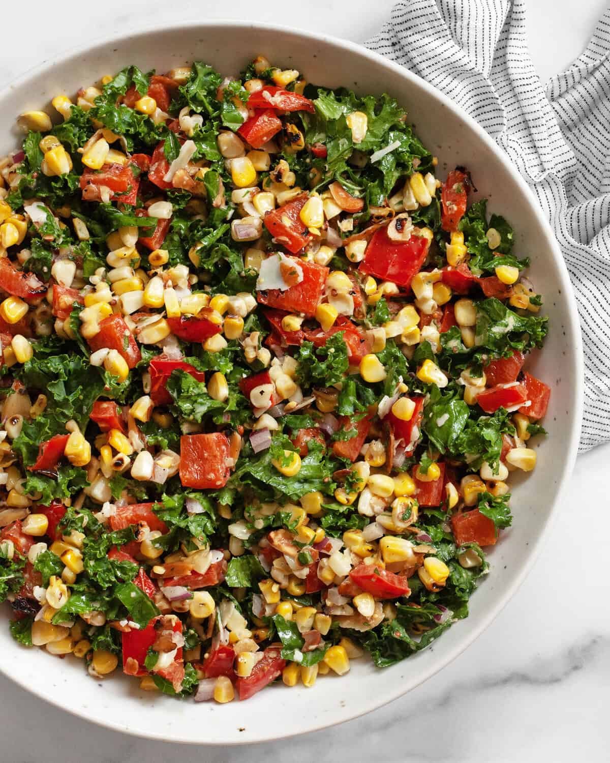 Grilled corn pepper kale salad in a bowl.