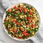 Grilled corn pepper kale salad in a bowl.