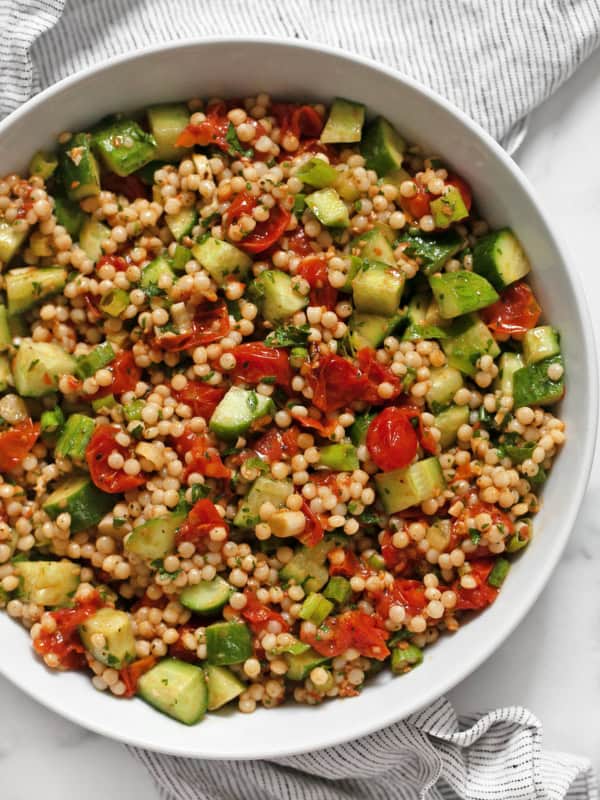 Harissa roasted tomato couscous in a bowl.