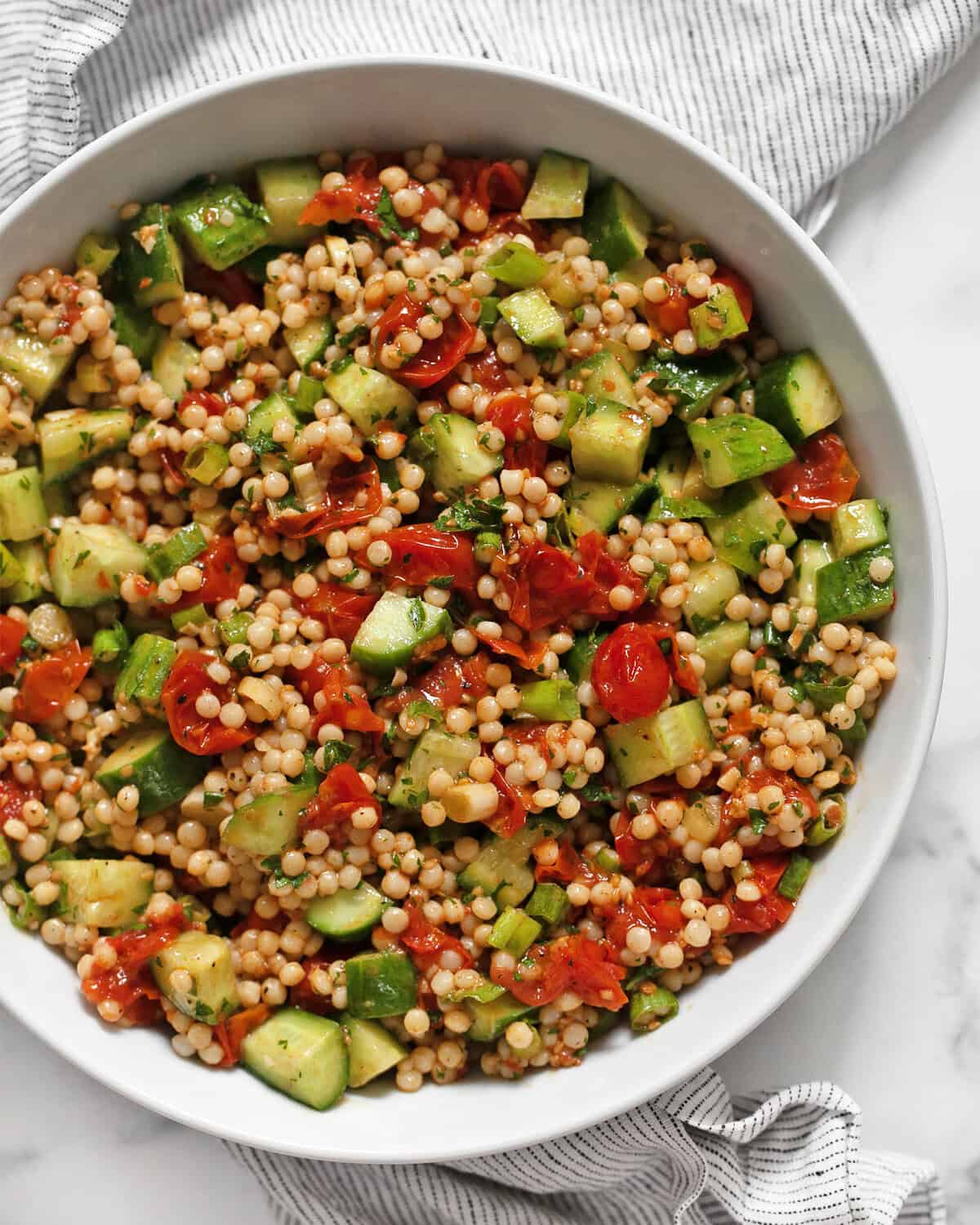 Harissa roasted tomato couscous in a bowl.