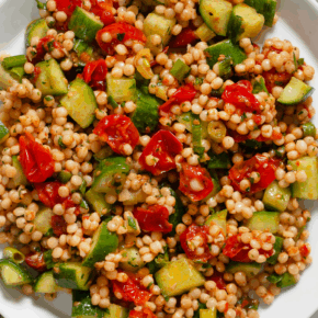 Harissa roasted tomato couscous on a plate.
