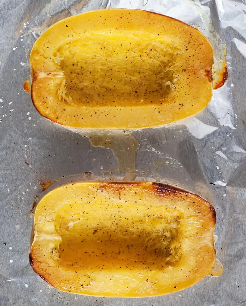 Halved spaghetti squash on a sheet pan