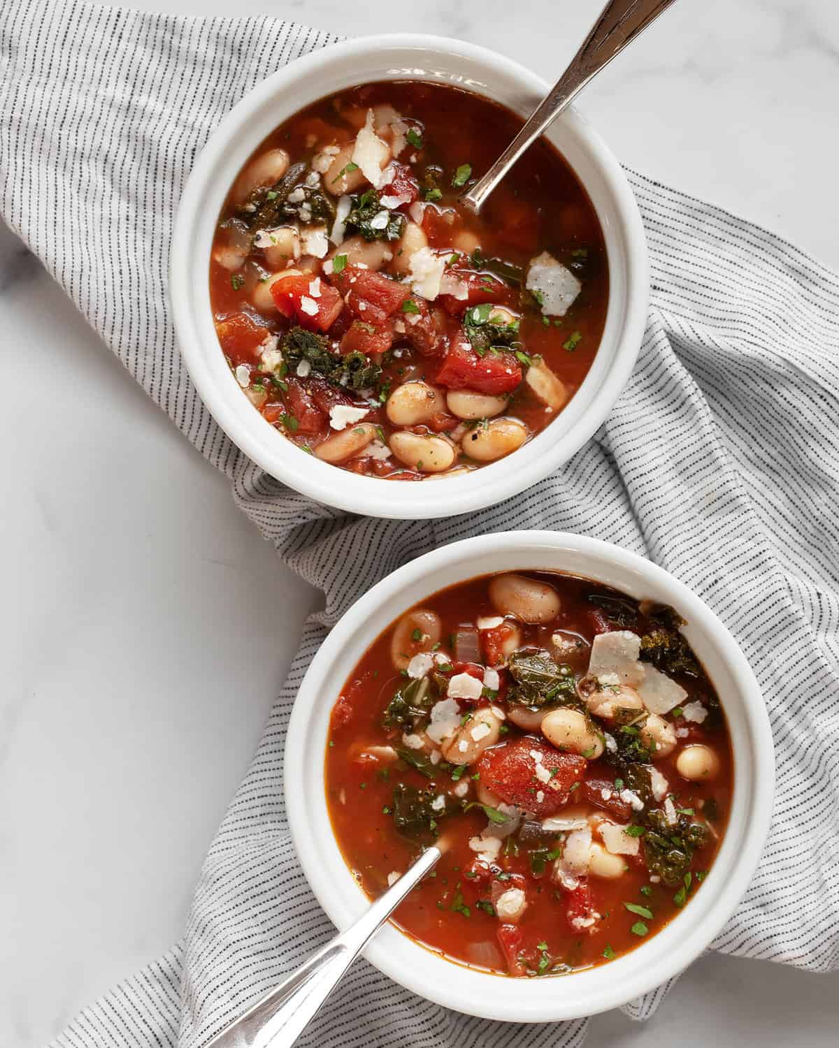 Two bowls of rosemary white bean tomato soup.