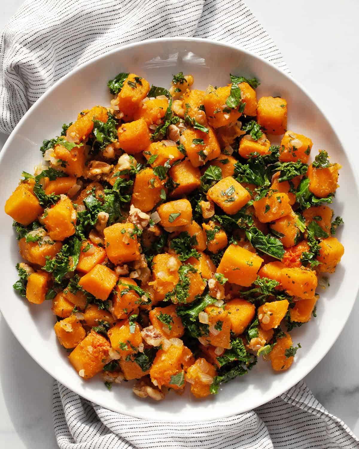 Sautéed kale and butternut squash on a plate.