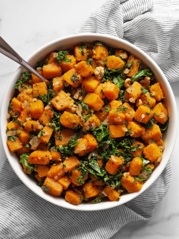 Sautéed butternut squash with kale in a bowl.