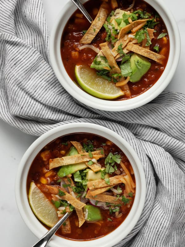 Two bowls of slow cooker tortilla soup.