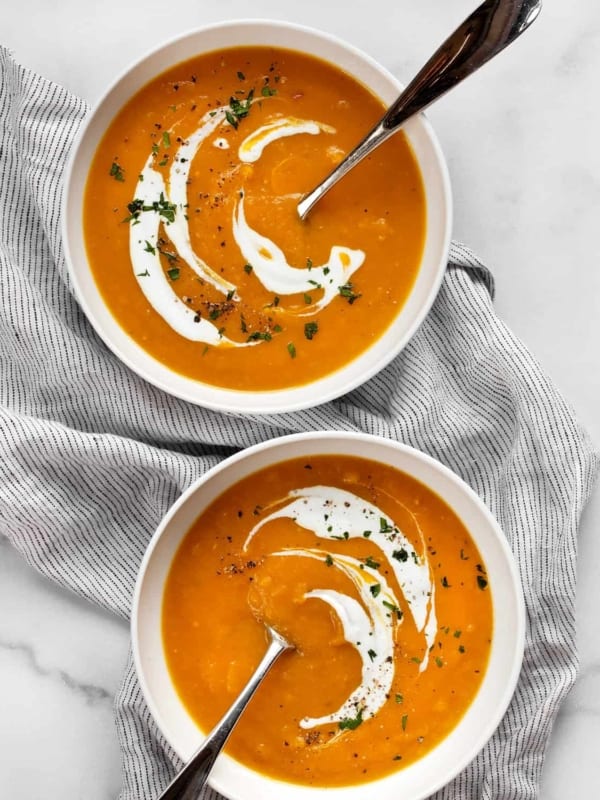 Two bowls of butternut squash apple soup.