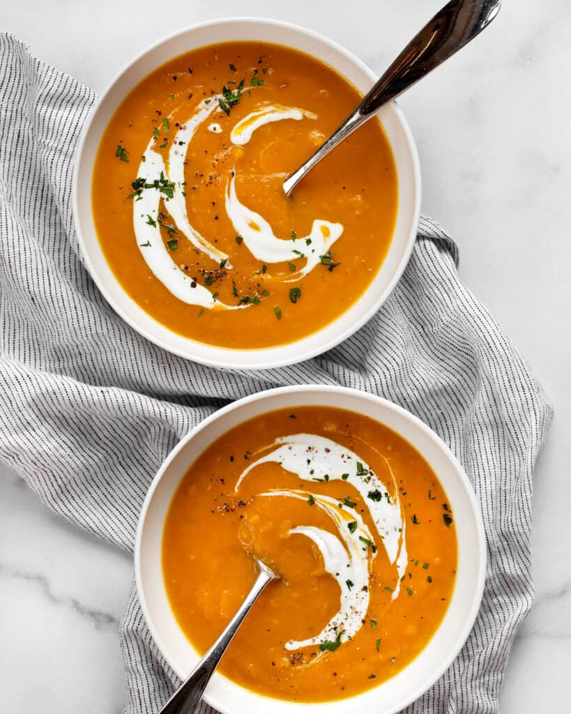 Two bowls of butternut squash apple soup.