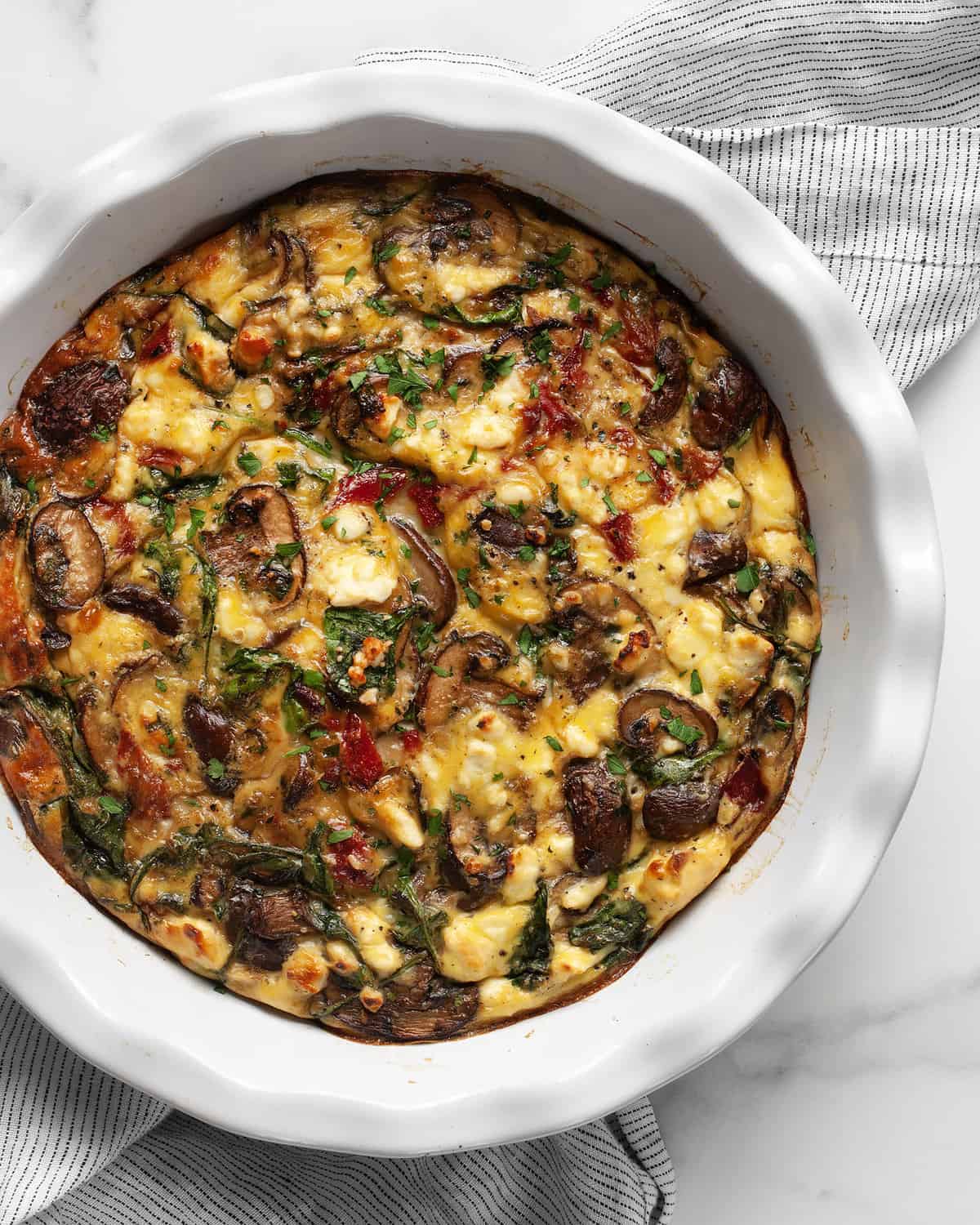 Crustless quiche with mushrooms, peppers, spinach and feta.