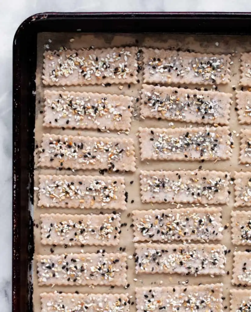Brush the crackers with water and sprinkle them with everything seasoning