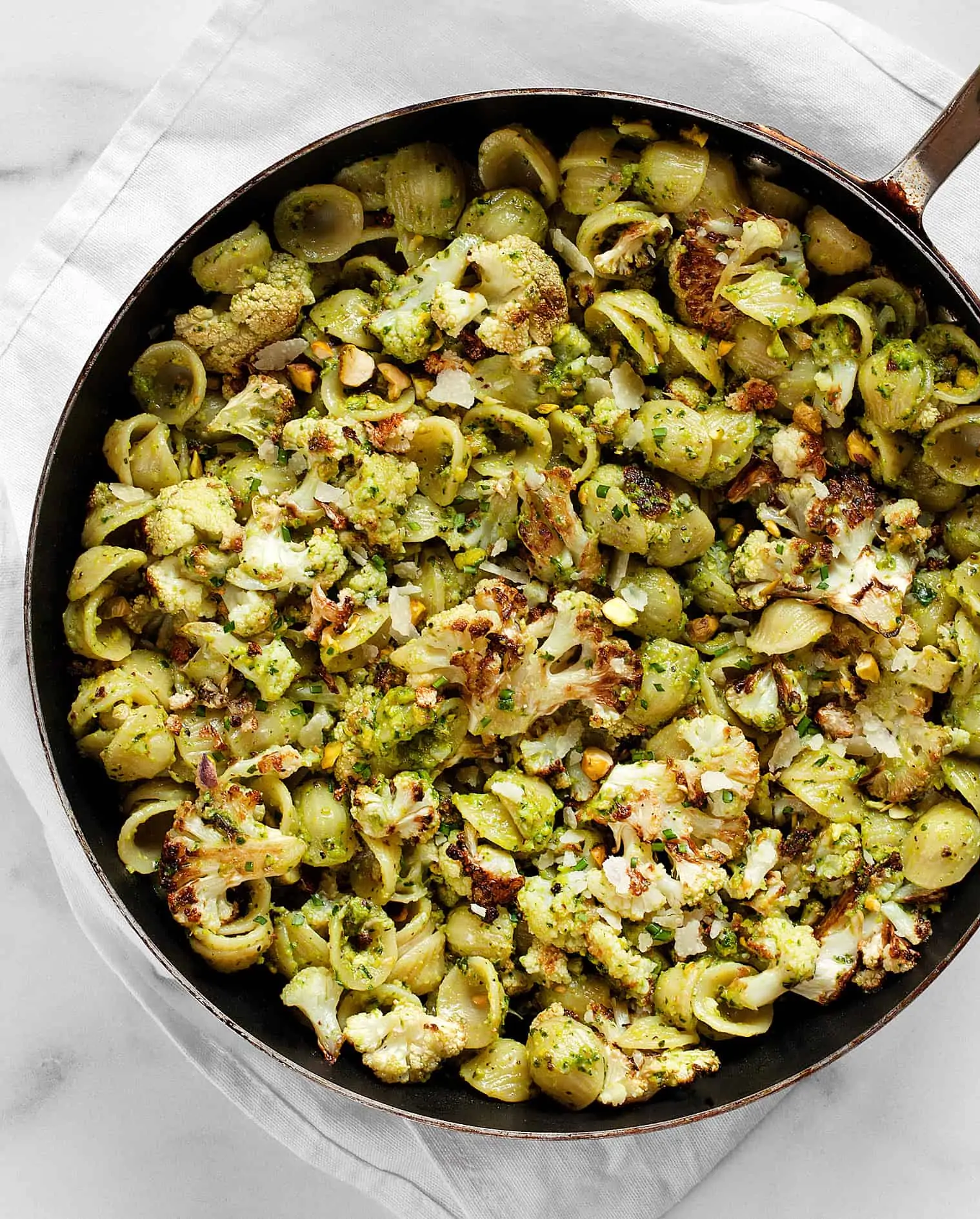 Roasted Cauliflower Spinach Pesto Pasta in a skillet