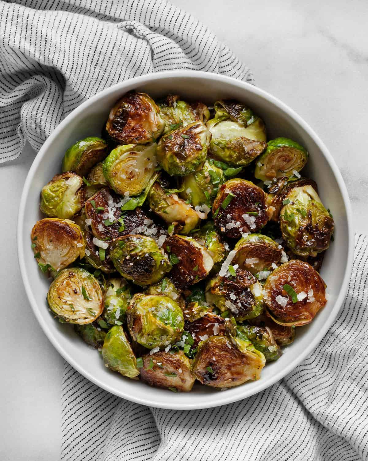 Brussels sprouts with Parmesan and honey mustard in a bowl.