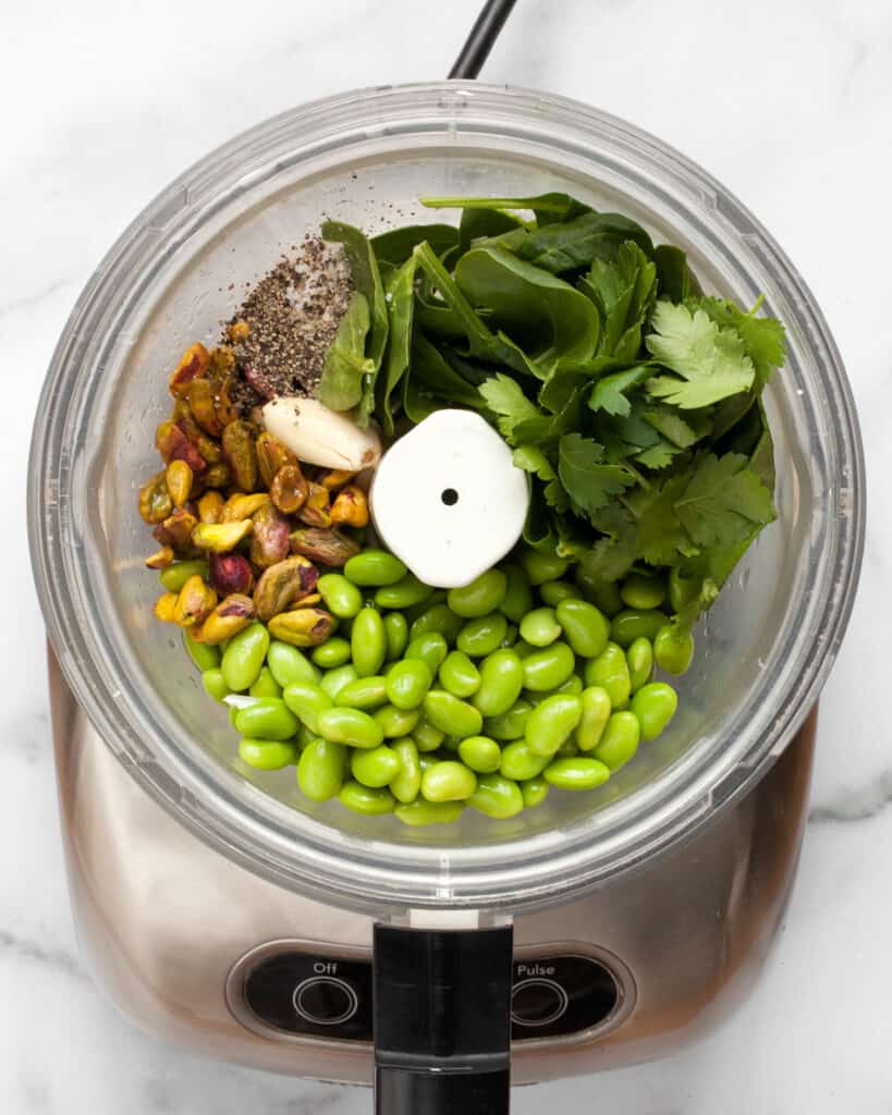 Edamame, herbs, nuts and garlic in a food processor