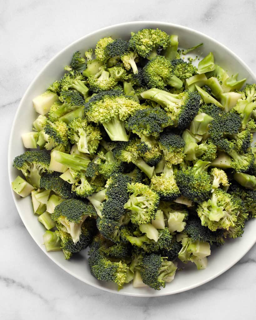 Broccoli florets and chopped stems on a plate
