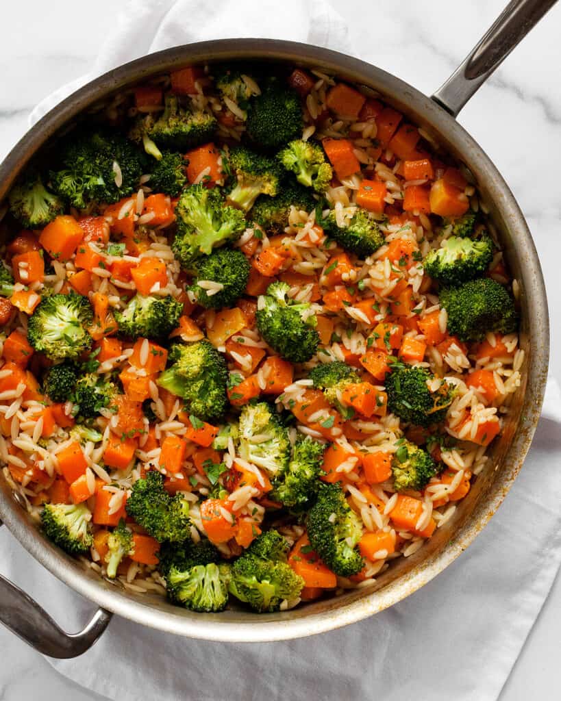 Orzo, butternut squash and broccoli in a skillet