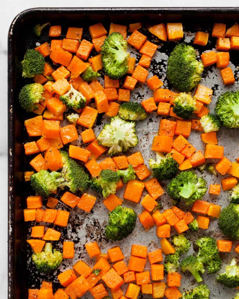 Roasted butternut squash and broccoli on a sheet pan