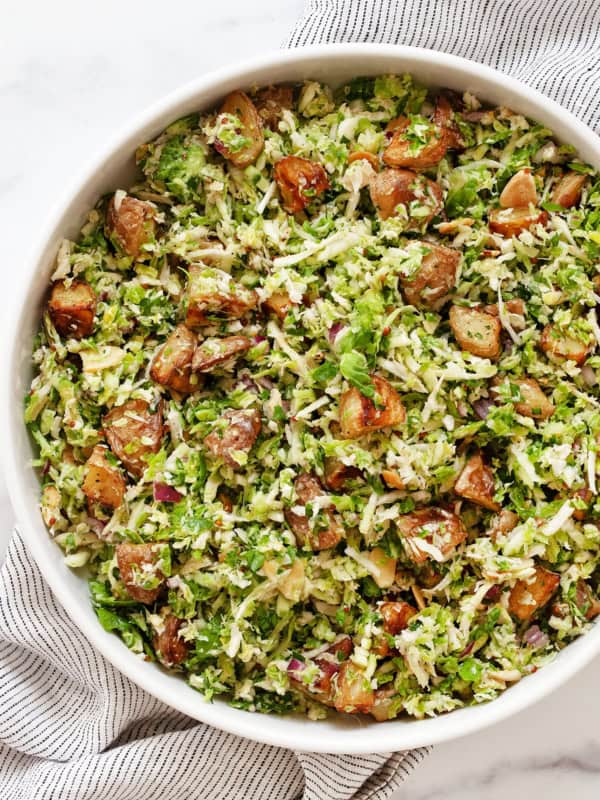 Roasted potato brussels sprout salad in a bowl.